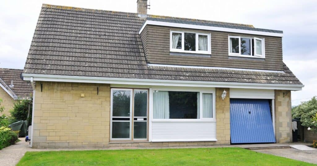 Damaged roof repair service on a suburban house to prevent water intrusion and property damage - Property Saviour.